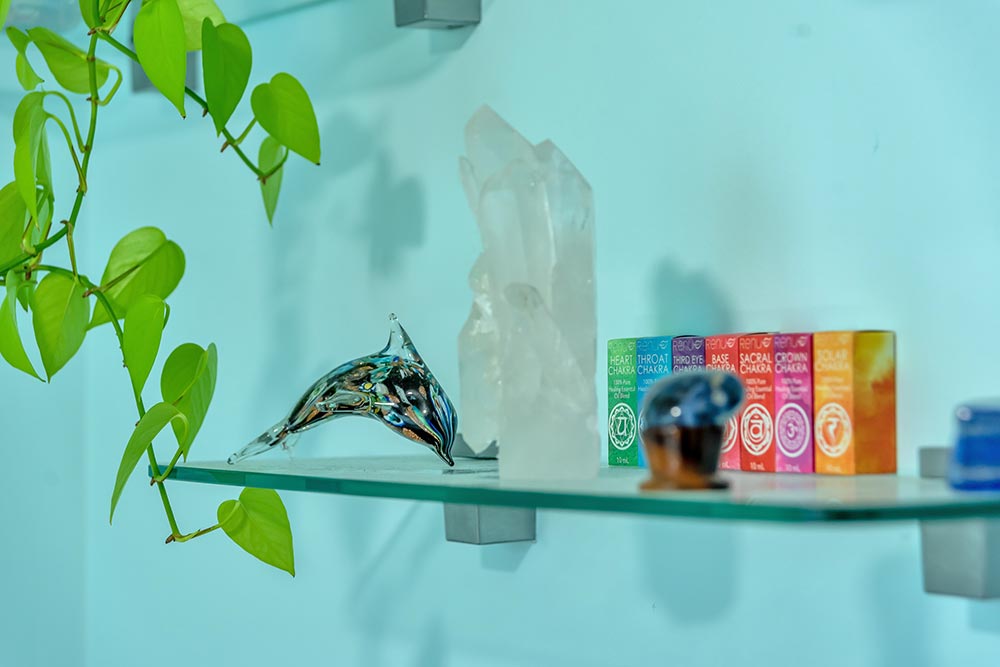 Flower Essence bottles on a display shelf with healing crystals