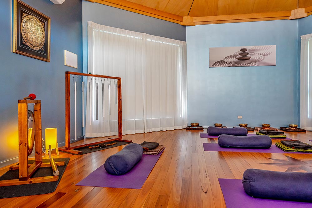 Sound Therapy setup in an octagonal room with purple floor mats and cushions