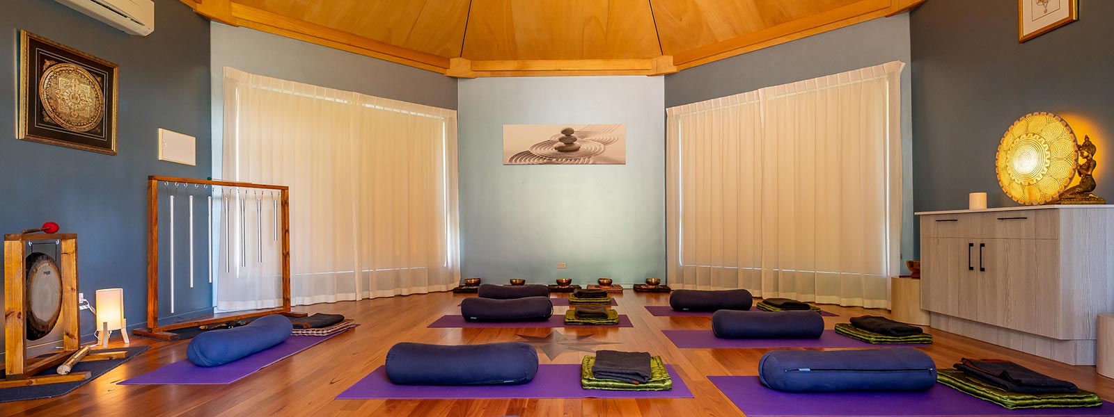 Octagonal Room hire set up with purple floor mats and cushions and sound therapy instruments