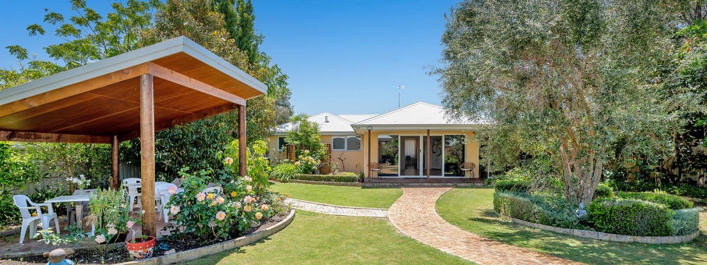 Pergola with beautiful flower garden looking back at venue hire at Sarah's Circle in Mandurah