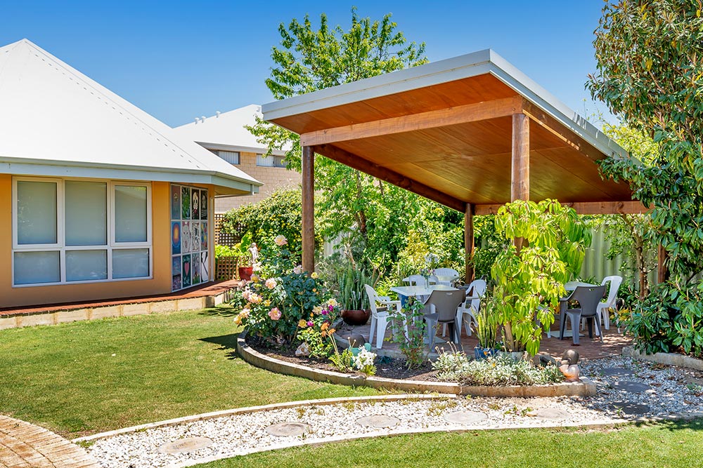 Pergola next to octagonal building in beautiful tranquil gardens